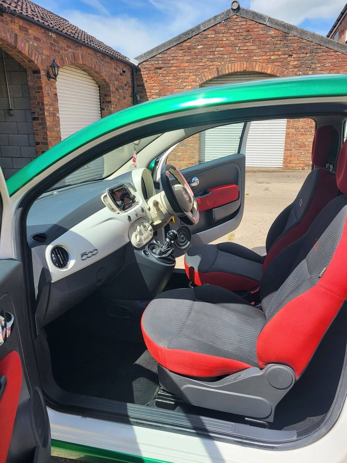 The same small car interior after valeting, seat fabric and carpets clean with the weave visible again